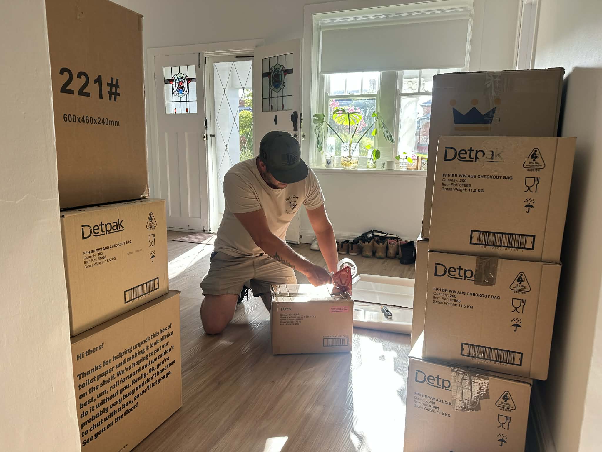 Removalist wrapping furniture in protective moving blankets